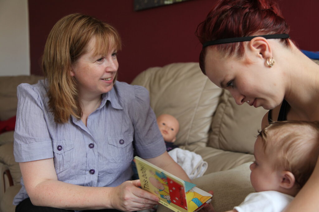 Family nurse talking to mother with child