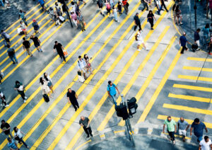 People crossing a road in several different directions