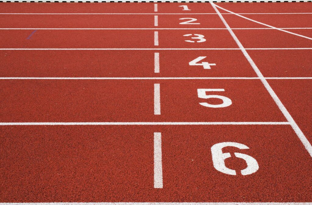 A race track with white lines and numbers from one to six