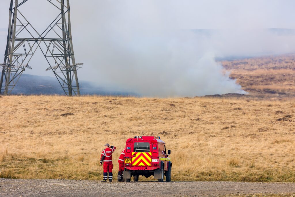 Fire engines and firefighters attending a large moorland grassfire in the South Wales valleys in 2022