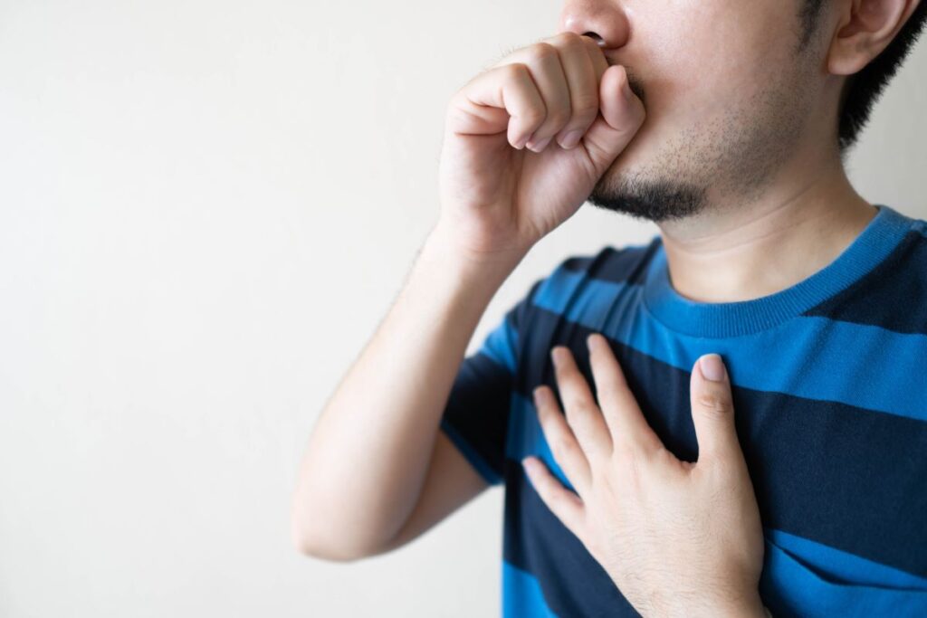 Young man coughing