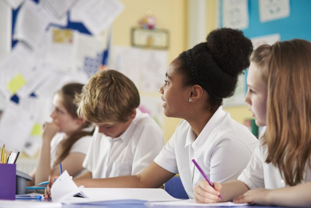 Primary school children wearing uniforms in a classroom